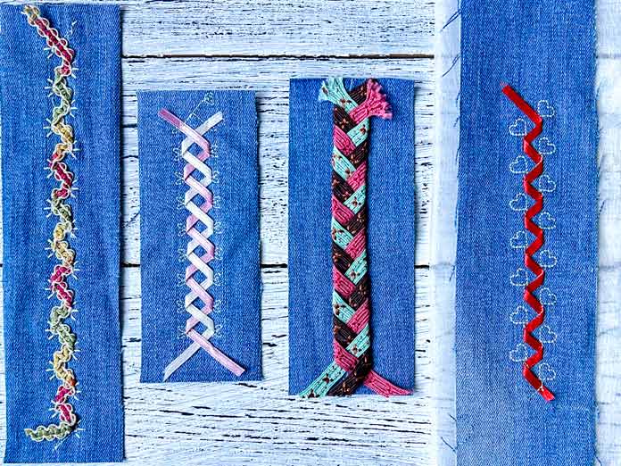 Four vertical denim fabric samples showing decorative ribbon stitches created using the PFAFF creative icon 2. Each sample features a different ribbon stitch technique: from left to right—single ribbon stitch# 8 made with lace, double ribbon stitch #3 made with a pink and cream ribbons, a triple ribbon stitch#8 made with woven ribbons, and a single ribbon stitch# 6 made in the hoop with red robbon.