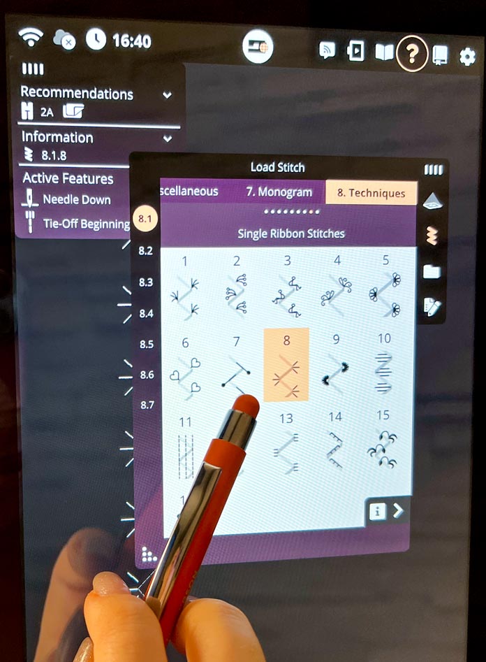 Close-up of the PFAFF creative icon 2 10.1" capacitive screen with Category 8 – Techniques selected under the Load Stitch menu. The user points to Stitch #8 from the 8.1 Single Ribbon Stitches subcategory using a stylus. The left panel displays the recommended presser foot (2A without IDT), the active stitch (8.1.8), and enabled features including “Needle Down” and “Tie-Off Beginning”. 