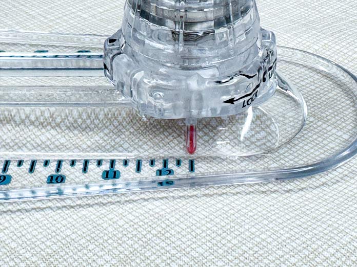 Locating the red lines under the TrueCut 360 Circle Cutter knob.