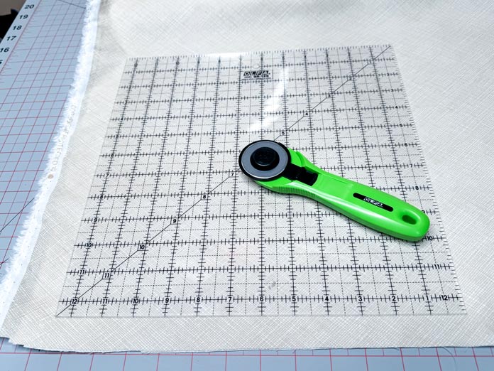 Cutting squares using the Olfa 12½” x 12½” square ruler and rotary cutter.