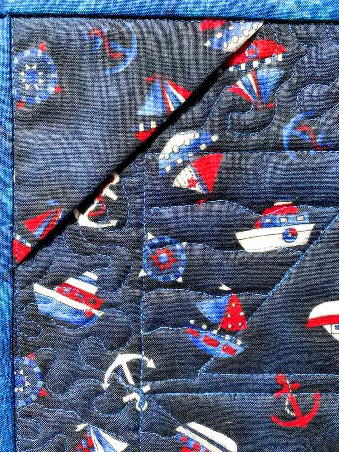 The hanging sleeve of the Ship Ahoy! Wall Quilt by Elaine Theriault for ANPTmag Issue 60; photo by Carla A. Canonico for ANPTmag