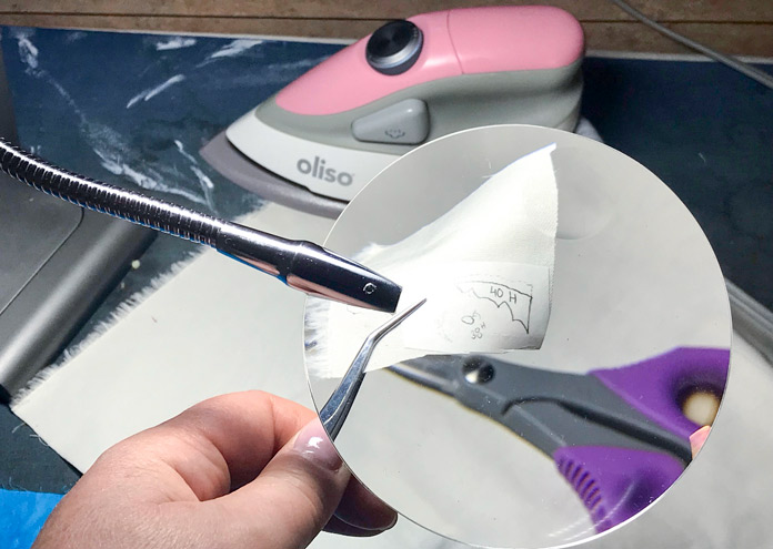 Using the magnifier, KAI scissors and UNIQUE Bent Tweezers to cut small pieces; UNIQUE Lighting Foldable LED Desk Lamp