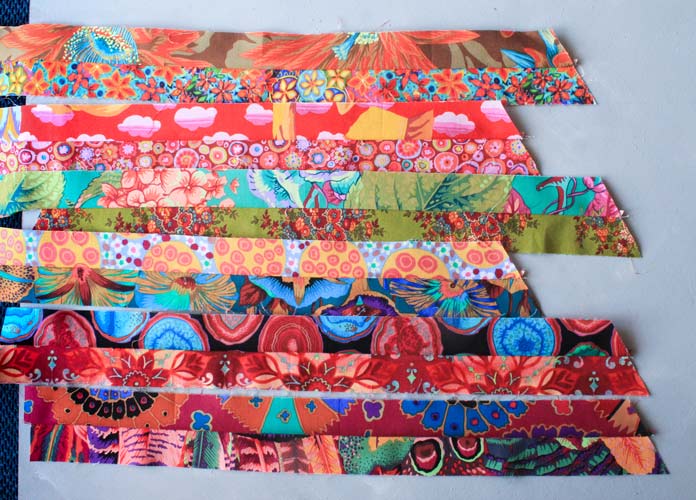 6 units of two strips of very vibrant fabric sewn together at a 60-degree angle
