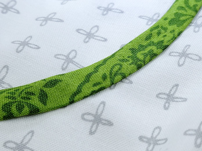 A strip of green fabric glued to a white background