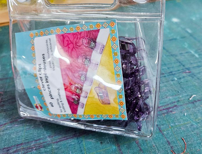 A plastic pouch of purple clips; Heirloom Clever Clips, Husqvarna VIKING ONYX 25