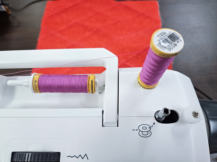 Two spools of pink thread on a white sewing machine; making a project bag using the Husqvarna VIKING ONYX 25