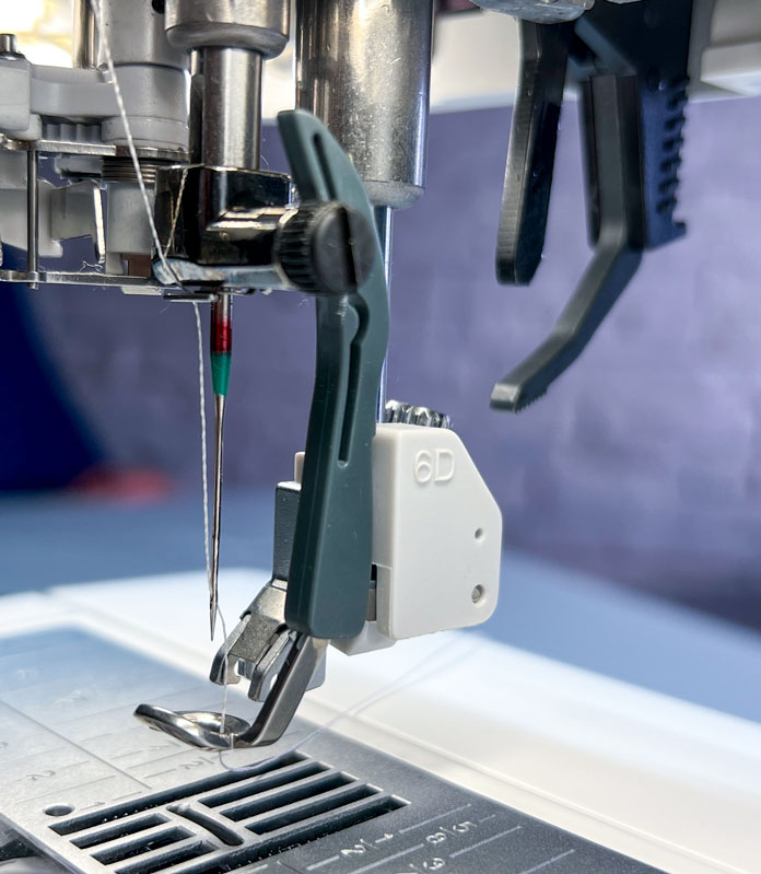 The Dynamic Spring Foot serves multiple purposes, catering to embroidery, free-motion sewing, and quilting needs. Its design offers an unobstructed view, ideal for executing stippling or following intricate fabric designs. 