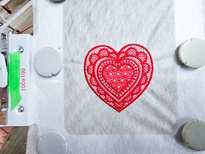 A red heart made from thread