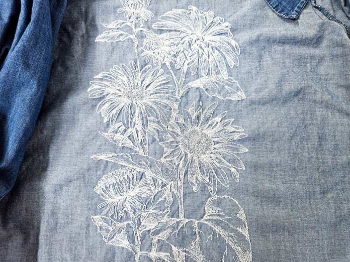 White stitching on a light blue shirt