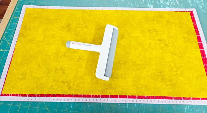 Yellow fabric on a digital cutter mat