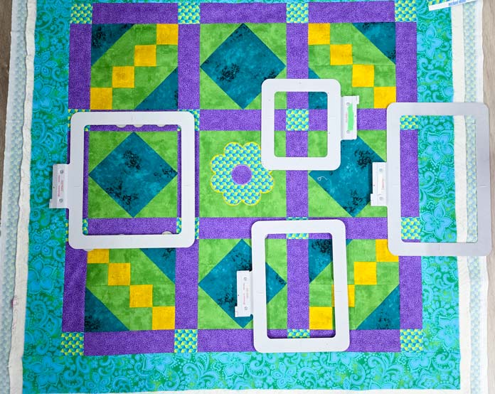 Four metal hoops on a quilt; Creativate Embroidery Software