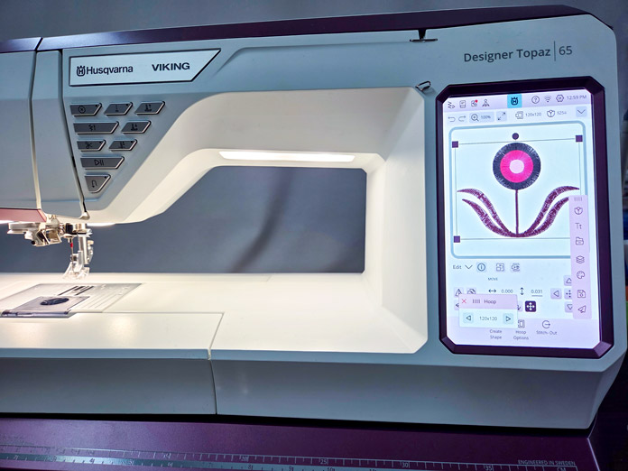 An embroidery machine with a design on the screen on the Husqvarna VIKING Designer Topaz 65