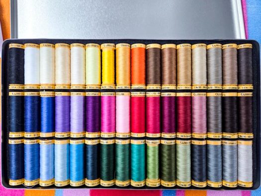 A 48-spool collection of colored sewing thread; Gütermann cotton thread