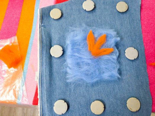 Blue and orange roving on denim