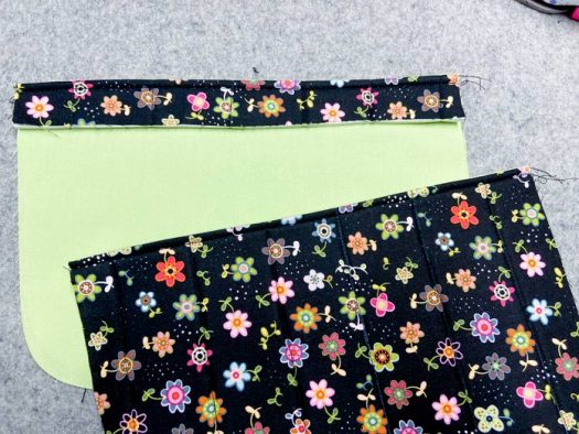 Two multicolored pocket sections lay on a grey pressing mat.