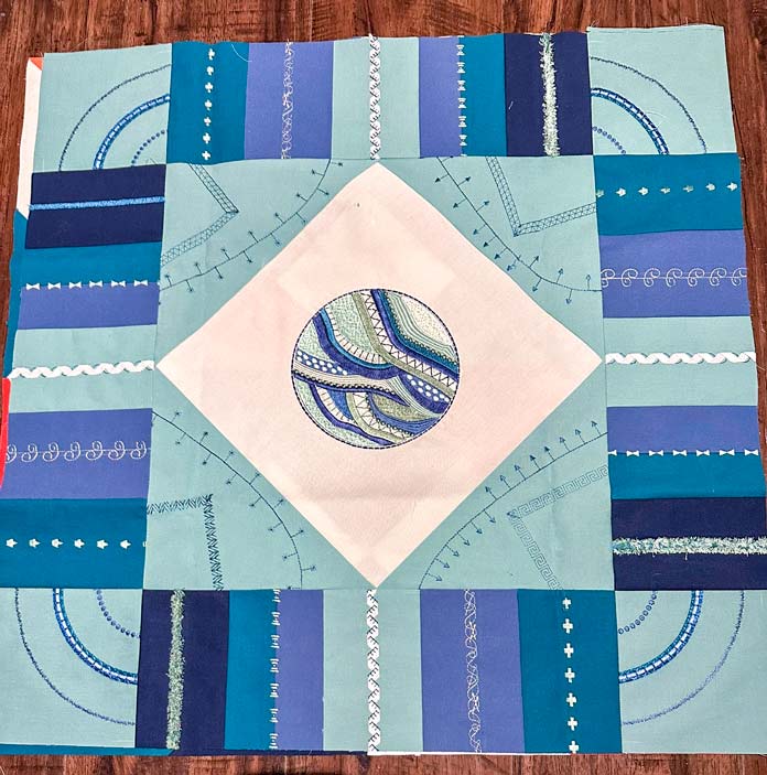 A blue and green fabric pieced square. 