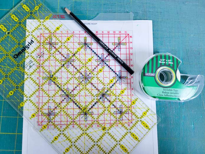 A quilter's ruler, a template pencil, a paper pattern, and tape
