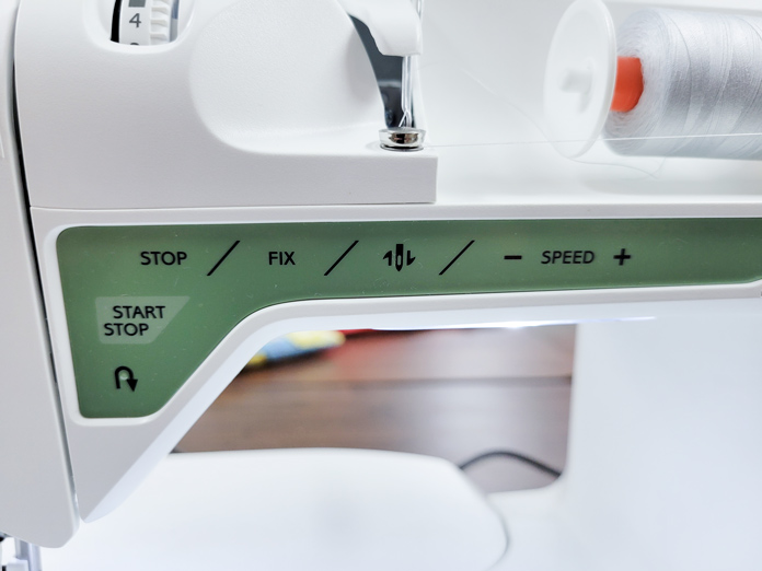A green panel on a white sewing machine with sewing functions; Husqvarna Viking Tribute 150C