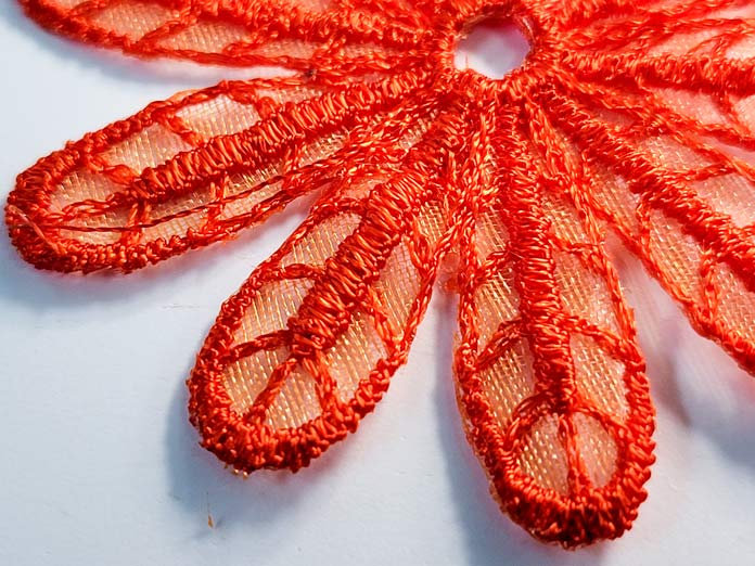 Orange thread stitched into a flower shape