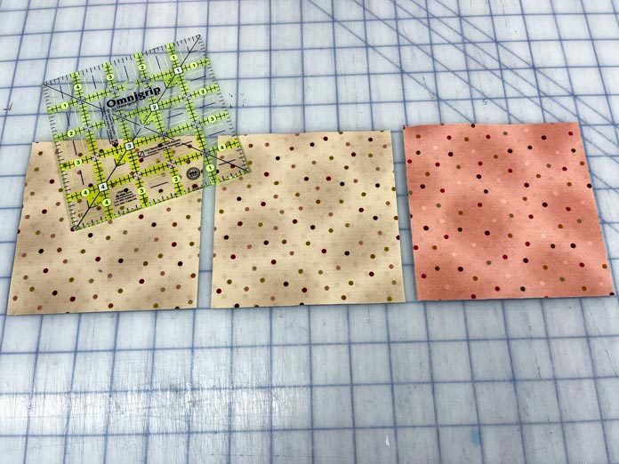 5" fabric squares that have been cut using the Omnigrip 5" ruler and an OLFA rotary cutter