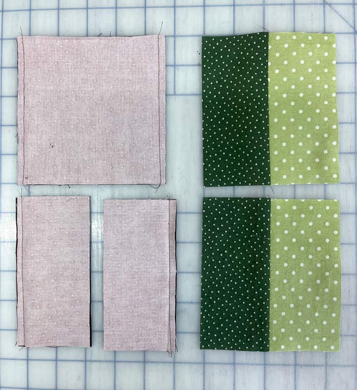 Pieced squares that have been made by sewing 2 – 5" squares together.