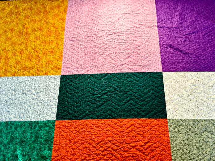 Nine different fabrics are used to make a queen-size quilt backing.
