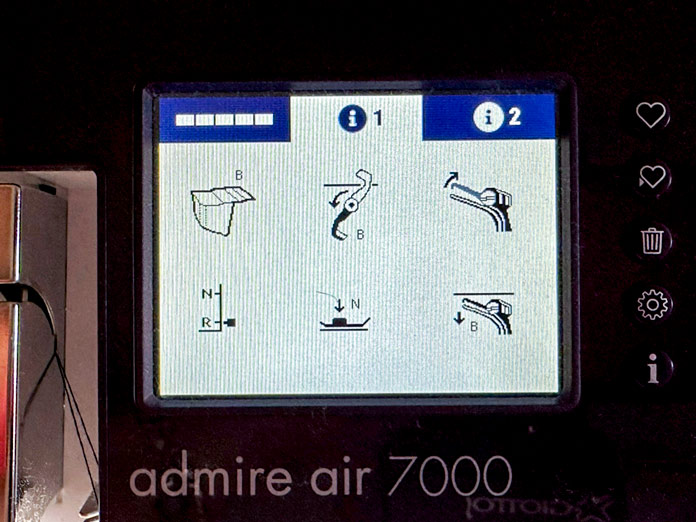 A computer screen from the purple and white serger showing pictures of things that need to be changed when moving into coverstitch mode: change to the B table, lower the knife, switch the stitch finger to R, lower the loopers; PFAFF admire air 7000