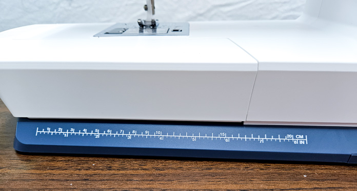 A ruler on the base of a sewing machine