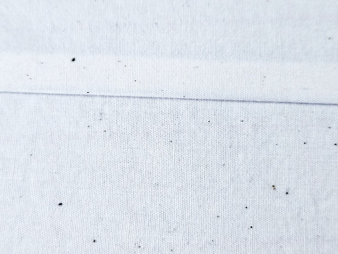 A seam in cream fabric