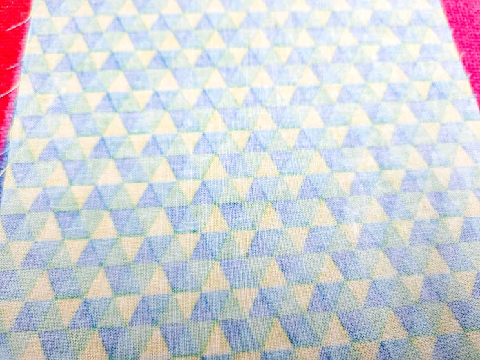 The wrong side of a blue, green, and yellow fabric