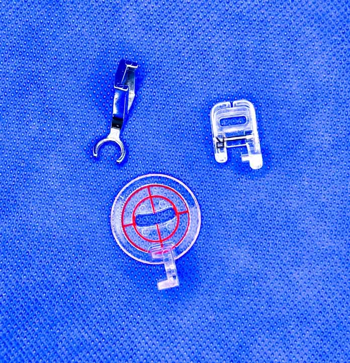 Three quilting presser feet for a sewing machine on a blue background