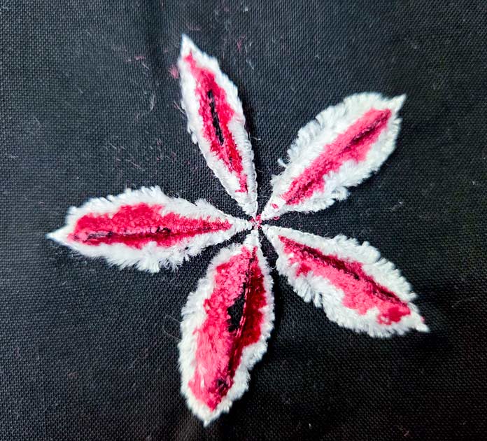 Red and white stitching on black fabric