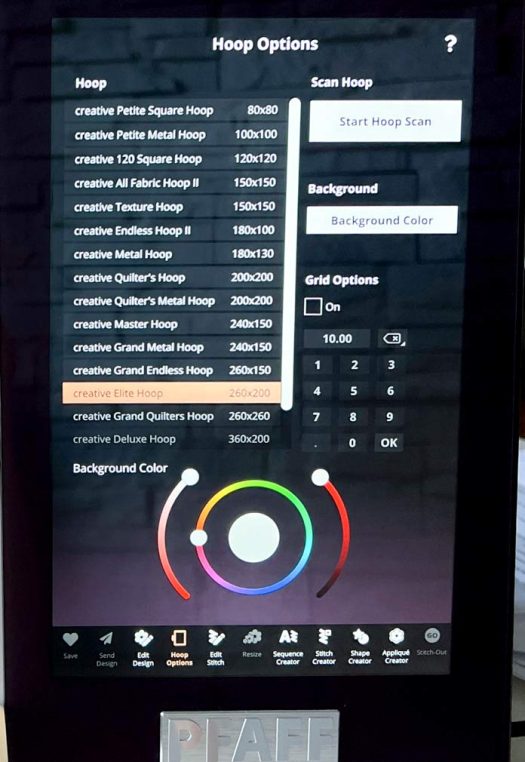 A close-up of the screen on the PFAFF creative icon 2 sewing and embroidery machine showing the “Hoop Options” menu. The creative Elite Hoop 260x200 is selected from a list of available hoops. The menu also includes options for grid configuration, background color adjustment, and hoop scanning. Below the screen are touch icons for tools such as “Edit Design,” “Hoop Options,” “Resize,” and “Stitch-Out.” 