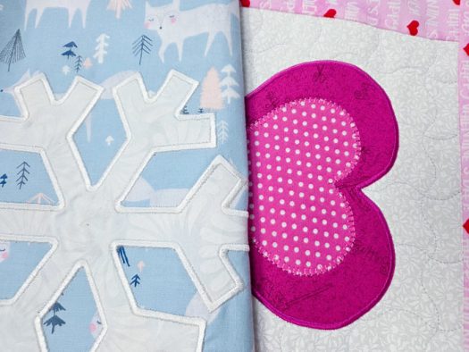A white snowflake on a blue fabric and a pink heart on white fabric; Gütermann cotton thread