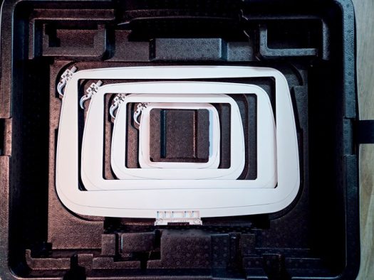 Four grey plastic hoops in a black case