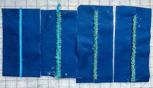Four pieces of navy fabric, 3½” x 7”. The first (on the left) has a turquoise chenille yarn couched down with a simple zigzag stitch. The next one has turquoise yarn couched down, then the Green Fringe stitch (cut open) on top. The next 2 are the same showing the New Fringe stitch in green thread stitched (and cut open) finished.