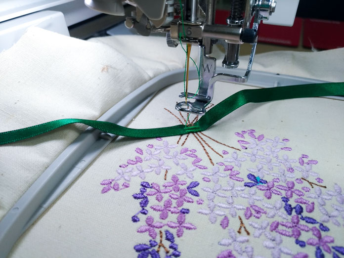 A green ribbon added to the lilac embroidery design; Brother Luminaire XP