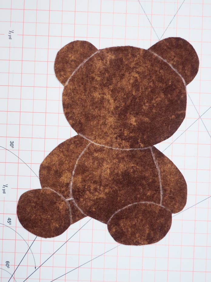 White lines drawn on the teddy bear fabric pieces ; Odif 808 Spray and Fix Temporary Adhesive for Paper Patterns, Odif 606 Spray and Fix No-sew Fusible Adhesive Web, Odif 404 Spray and Fix Permanent Repositionable Adhesive for Craft Material, Odif 505 Temporary Quilt Basting Adhesive Fabric Spray. 