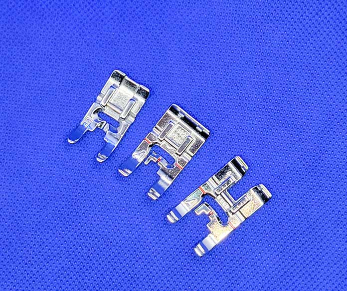 Three metal presser feet for a sewing machine in three different sizes on a blue background