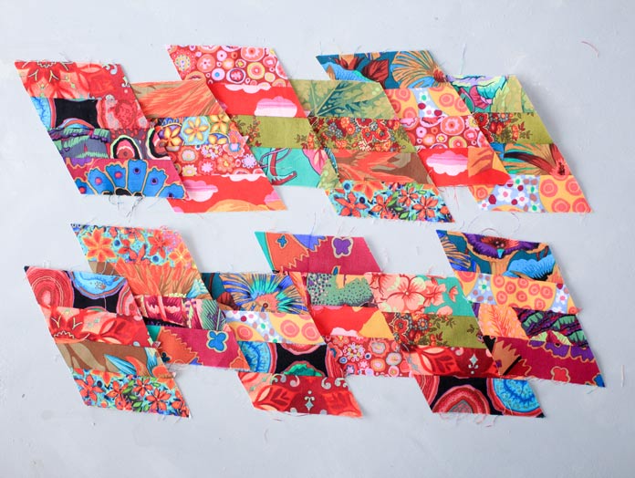 12 units of four 3½” strips of fabric in vibrant colors stitched together at a 60-degree angle