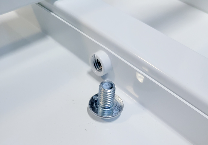 A short screw beside the opening on a white metal table