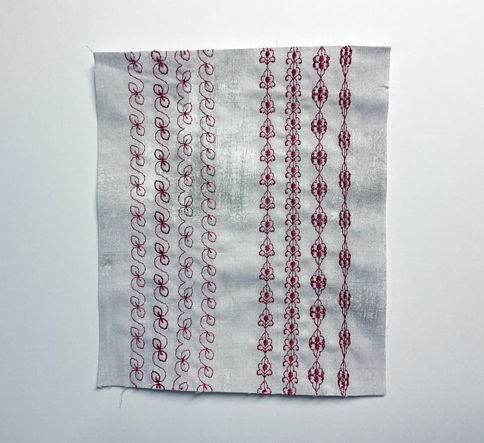 A piece of beige fabric with 8 rows of different stitches in red thread 