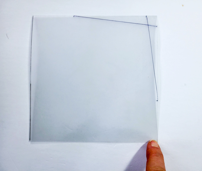 A piece of clear template plastic with two angled lines
