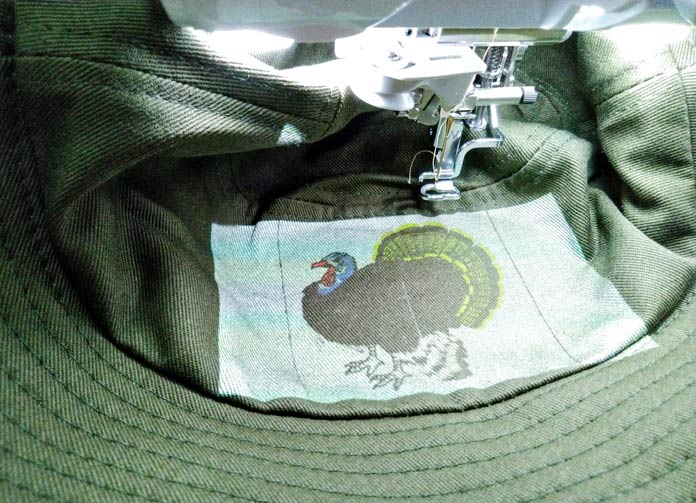 Using the projector feature to help line up the turkey design on the bucket hat. Brother Luminaire XP