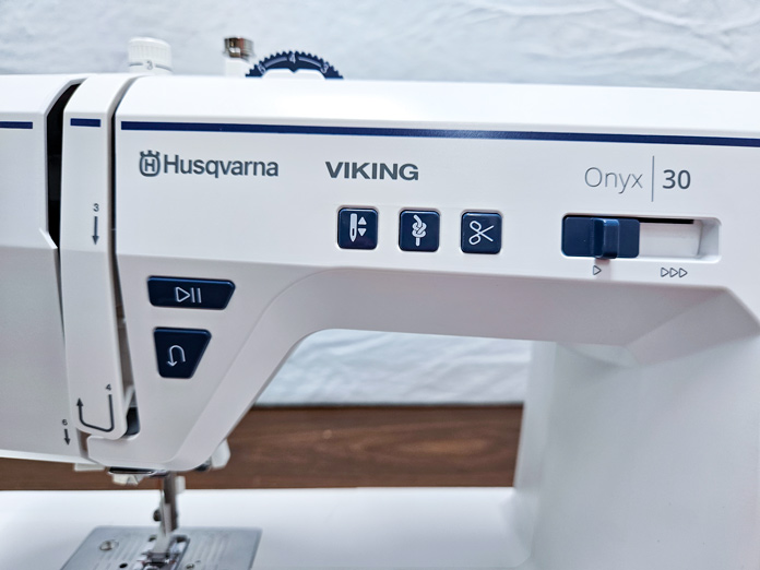 Black buttons on a white sewing machine