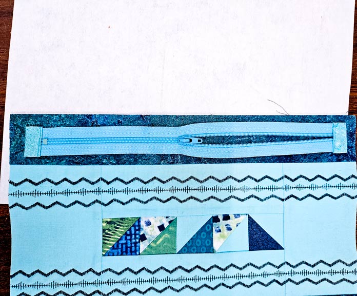 A blue zipper on blue fabric