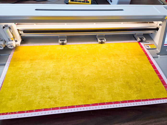 Yellow fabric on a digital cutting mat