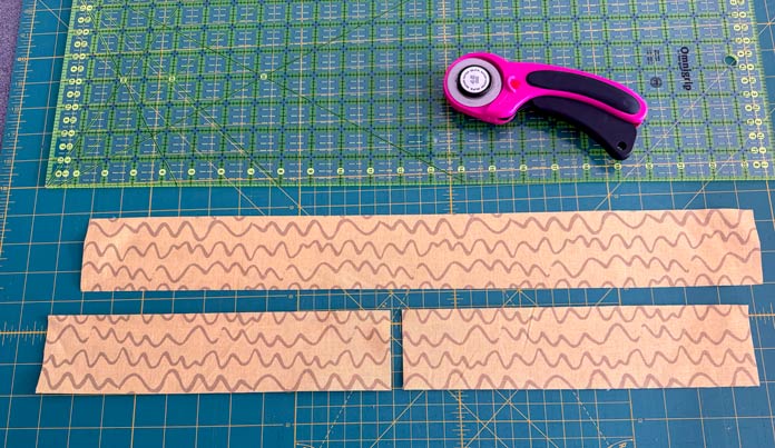 A strip is cut in two then one of the two pieces is the also cut in two.