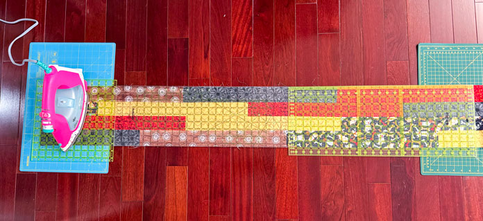A strip measuring 58½” long is being cut.