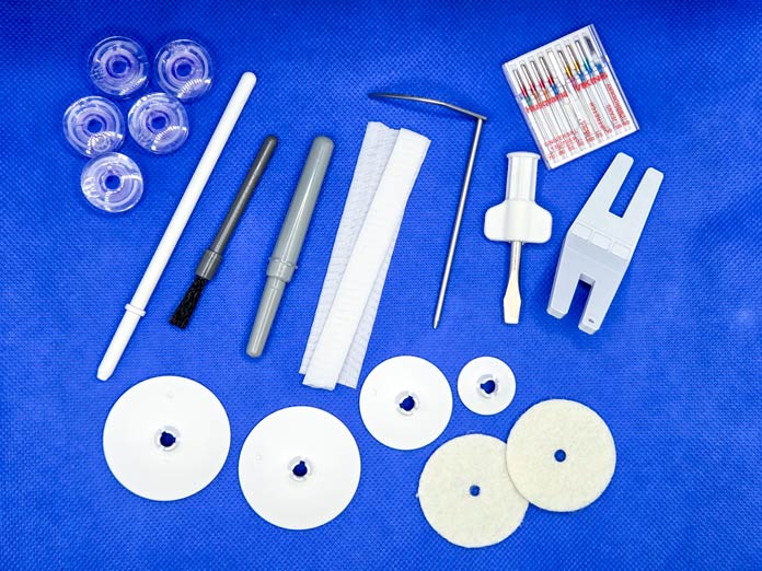Sewing machine accessories on a blue background